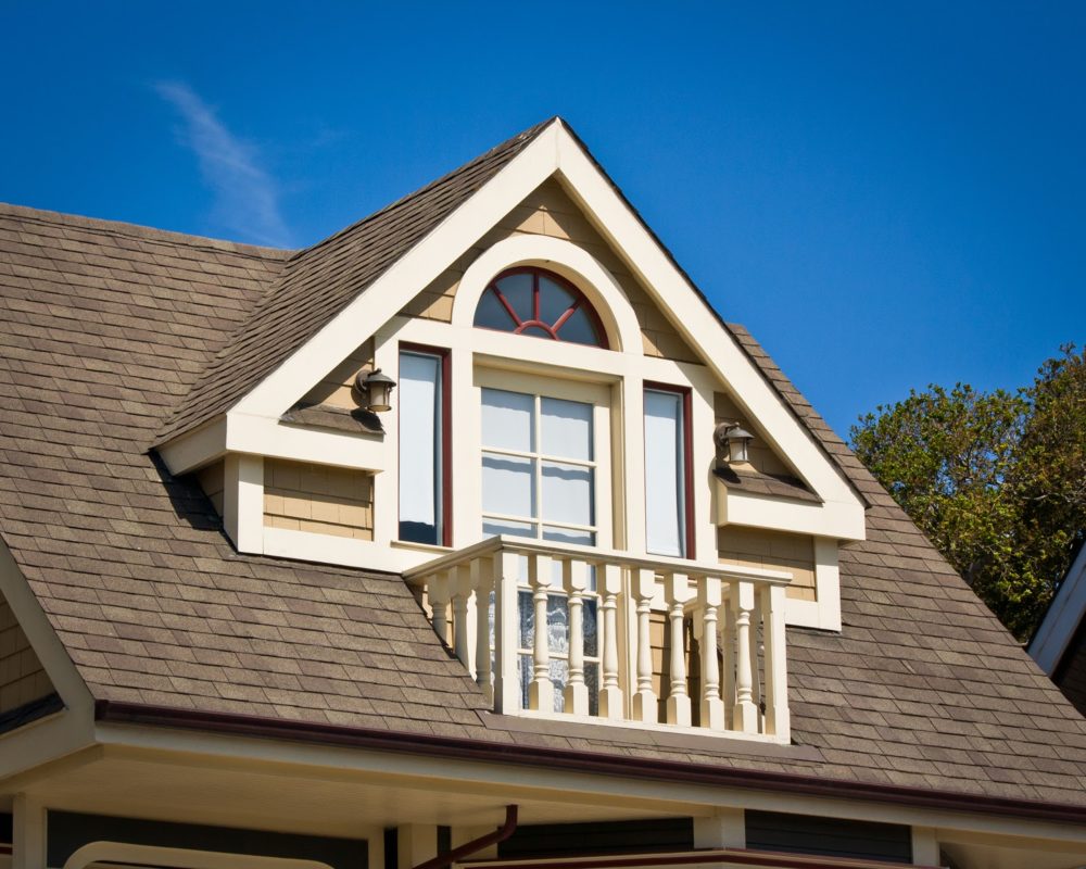 A prominent dormer balcony in the Victorian style.